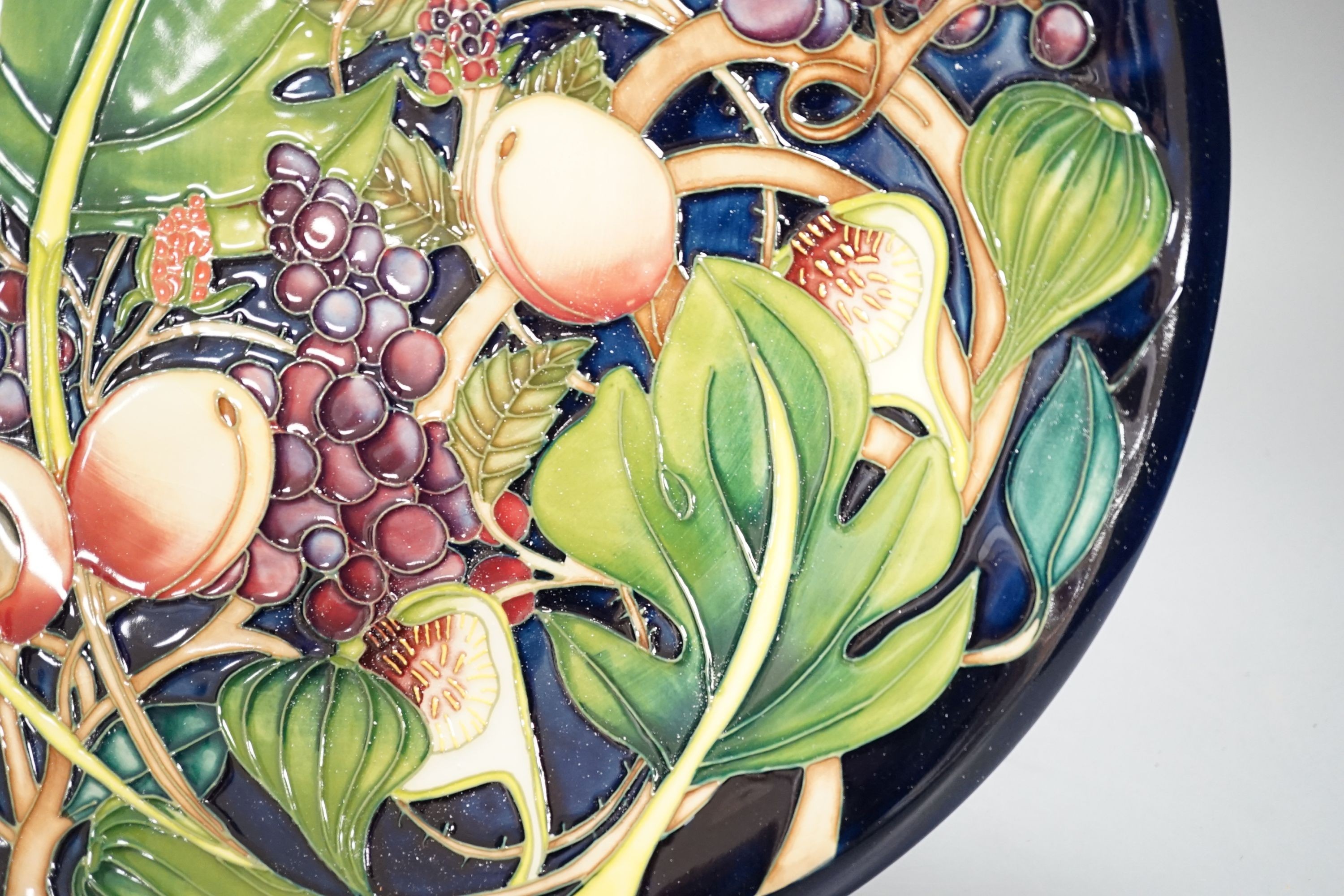 A Moorcroft Queen’s Choice pattern wall charger, dated 2003, signed by Emma Bossons, 36cm., in original box